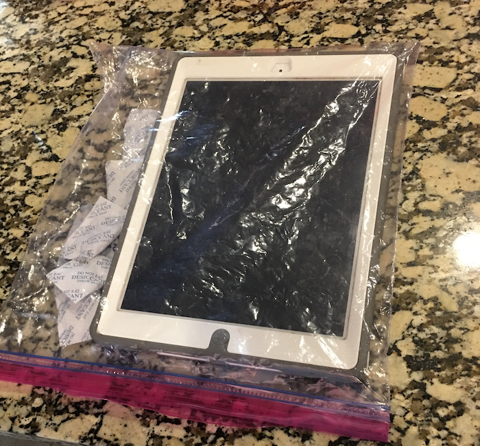 Drying out an iPad headphone jack using silica gel packets.